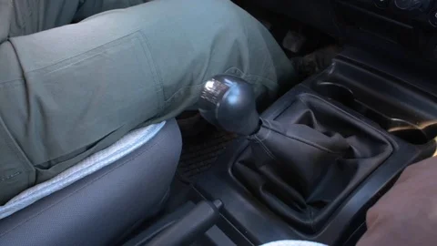 Close up of man's hands changing gear in a Suzuki SUV at dawn Stock Footage 121397474