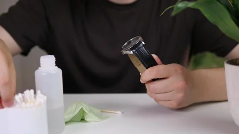 Close-up of a mans hands cleaning an expensive wristwatch and then wiping it Stock-Footage 313866856
