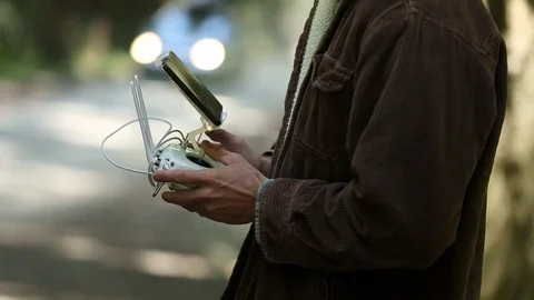 Close Up of man's hands on controller as he flies his drone Stock Footage 73026300