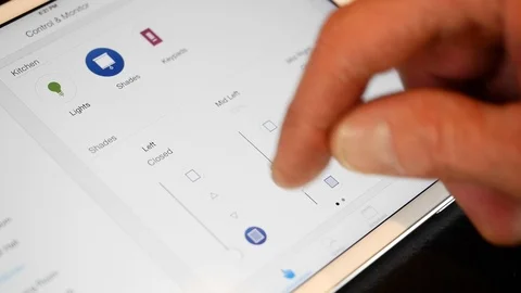 Close-up of man's hands controlling smart home systems on iPad. Video stock 98013896