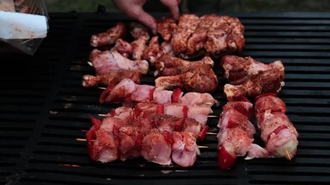 Close-up of man's hands cooking meat over an open flame, showcasing barbecue tec Stock Footage 280186545