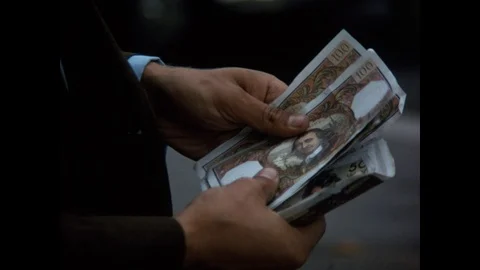 Close up of man's hands counting 100 franc banknotes in Paris, 1970 Stock Footage 85827066