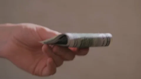 Close-up of a man's hands, counting dollar bills and give bills to another Stock Footage 120666761