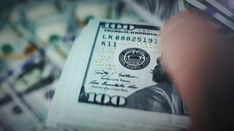 Close-up of a man's hands counting a large stack of cash American dollars Stock Footage 232866319