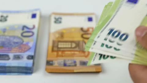 Close-up of a man's hands counting one hundred euro bills. In the background Stock-Footage 208076802