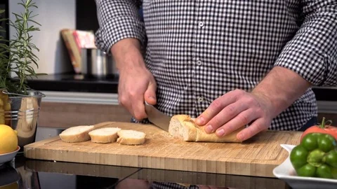 Close up on man's hands cutting baguette. 動画素材 70644055