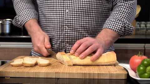 Close up on man's hands cutting baguette. Slider shot. Vídeos de archivo 70644510