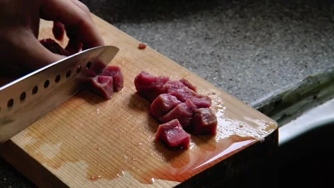 Close-up of a man's hands cutting beef Stock Footage 290884695