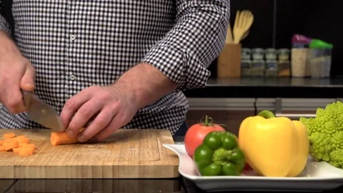 Close up on man's hands cutting carrot. Slider shot. 動画素材 70621638