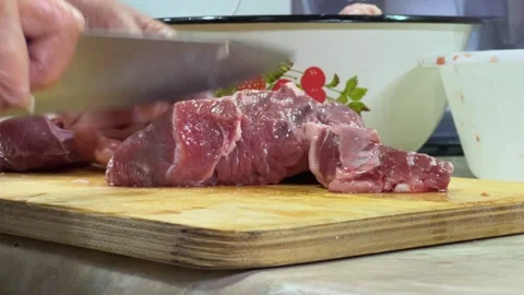 Close-up of man's hands cutting fresh meat on cutting board Stock Footage 329850203