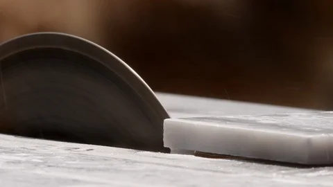 Close up of a man's hands cutting subway marble stone on a wet saw. Stock Footage 129099783