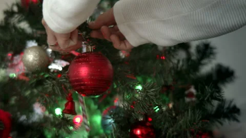 Close-up of man's hands decorating Christmas tree Stock Footage 143191145