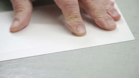 Close-Up of Man's Hands Drawing a Line with a Compass on White Paper Stock Footage 278935751