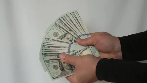 Close up of man's hands fanning out $100 bills, hands holding cash dollars Vídeos de archivo 335040638