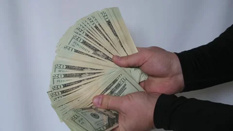Close up of man's hands fanning out $20 bills, hands holding cash dollars Vídeos de archivo 335040698