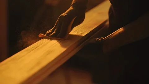 Close up of man`s hands grinding plank with sandpaper in workshop during the Stock Footage 114697136