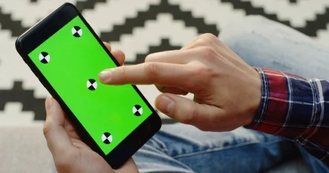 Close up of the man's hands holding black smartphone with green screen and Stock Footage 83049956