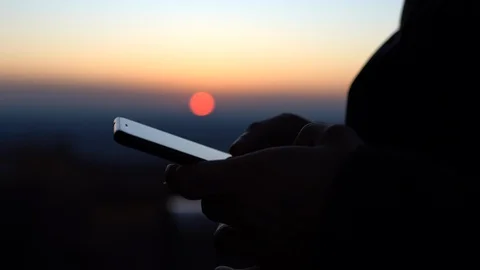 Close-up of man's hands holding cellphone, browsing internet, chatting online Stock Footage 129141392