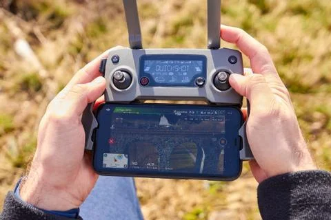 Close up mans hands holding a drones remote controller. A aerial shoot of a Stock Photos