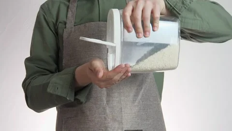 Close-up of a man's hands holding a jar of rice Stock Footage 312005864