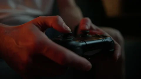 Close-up of a man's hands holding a joystick from a video console Stock Footage 220056034