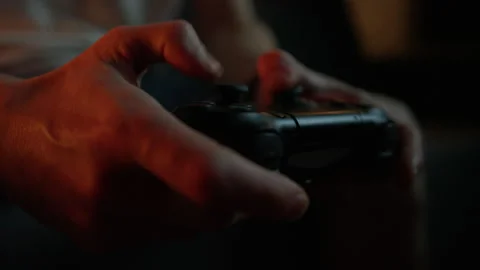 Close-up of a man's hands holding a joystick from a video console Stock Footage 258891559