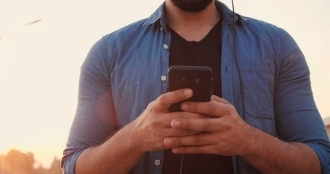 Close up of Man’s Hands Holding Smartphone. Portrait of Young Handsome Man Stock Footage 97926569