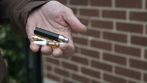 A close-up of a man's hands holding vaping paraphernalia. Stock Footage 120424399