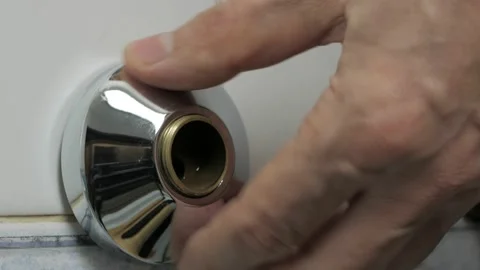 Close-up of a man's hands installing a new water faucet in a shower stall Stock Footage 167544157