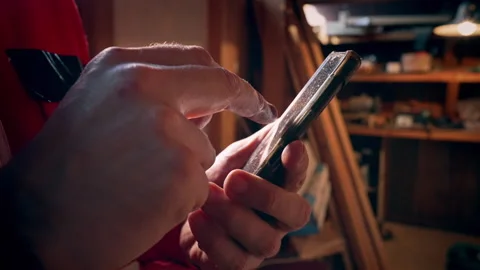 A close-up of a mans hands interacting with a smartphone. Video stock 318588519