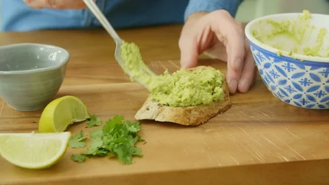 Close-up Of Man's Hands Making Avocado On Toast Stock Footage 86073017