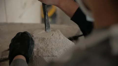 Close-up of man's hands making a stone sculpture using a chisel. Stock Footage 272154841