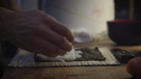 Close-up of man's hands making a sushi. Stock Footage 99890802