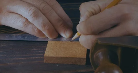 Close-Up Of Mans Hands Marking A Wooden Detail With A Pencil And A Ruler Stock Footage 121991518