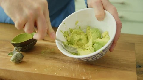 Close-up Of Man's Hands Mashing Avocado With Fork In Bowl Stock Footage 86072930