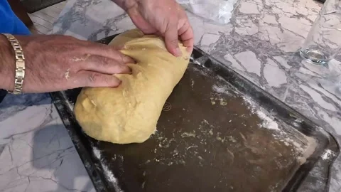Close up man's hands mixing bread batter on tray Stock Footage 258679009