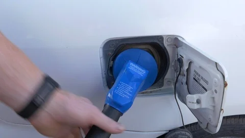 Close-up of man's hands opening gas cap and inserting nozzle. Stock Footage 100524218
