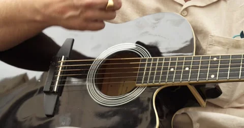 Close up of mans hands playing acoustic guitar.Musical instrument Stock Footage 165357512