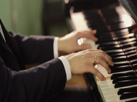 Close up of a man's hands playing a piano Stock Footage 70224314