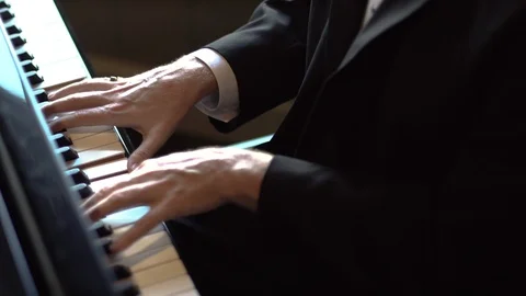 Close up of a mans hands playing the piano Stock Footage 87296493