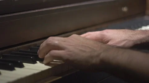 Close-up of man's hands playing the piano Stock Footage 122184299