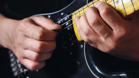 Close-up of a man's hands playing a string pulling solo on a electric guitar Stock Footage 276745462