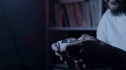 Close up of man's hands playing video game with controller at night Stock Footage 320020386