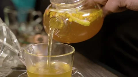 Close-up of man's hands pouring hot delicious fruit tea. Stock Footage 106345131