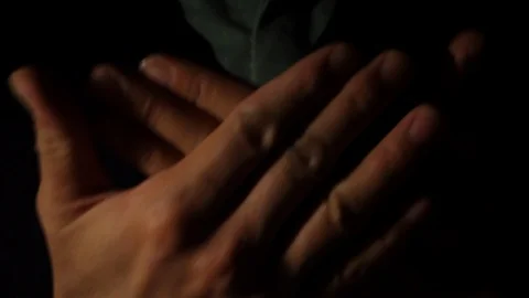 Close up of man's hands praying with dark background Stock Footage 121232945