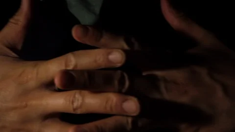 Close up of man's hands praying with dark background Stock Footage 121233028