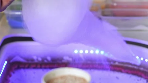 Close up mans hands preparing cotton candy and twirling it around fairy floss Stock Footage 280228165