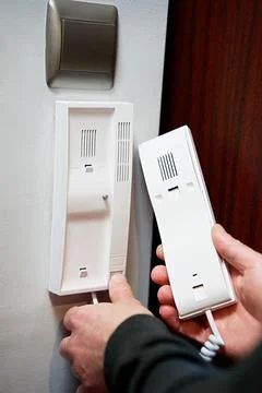 Close-up of man's hands pressing a button on a digital intercom Stock Photos