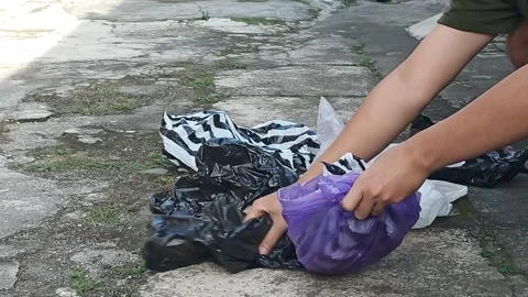 Close up of a man's hands putting garbage Stock Footage 315478830