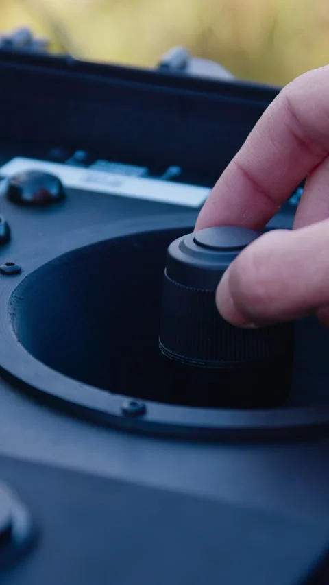 Close-up of a mans hands remotely piloting a drone to a laptop computer in an Video stock 314307470
